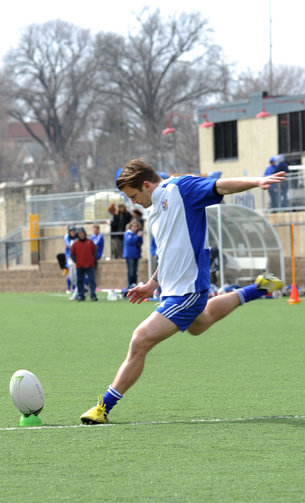 Eirik Hartley, Kansas City Blues Rugby Club player, kicks a successful 2-point conversion during a game against the University of Kansas Jayhawks in Kansas City, Mo., March 16, 2013. Rugby is a highly physical sport played with little protective equipment.  (U.S. Air Force photo by Senior Airman Brigitte N. Brantley/Released)