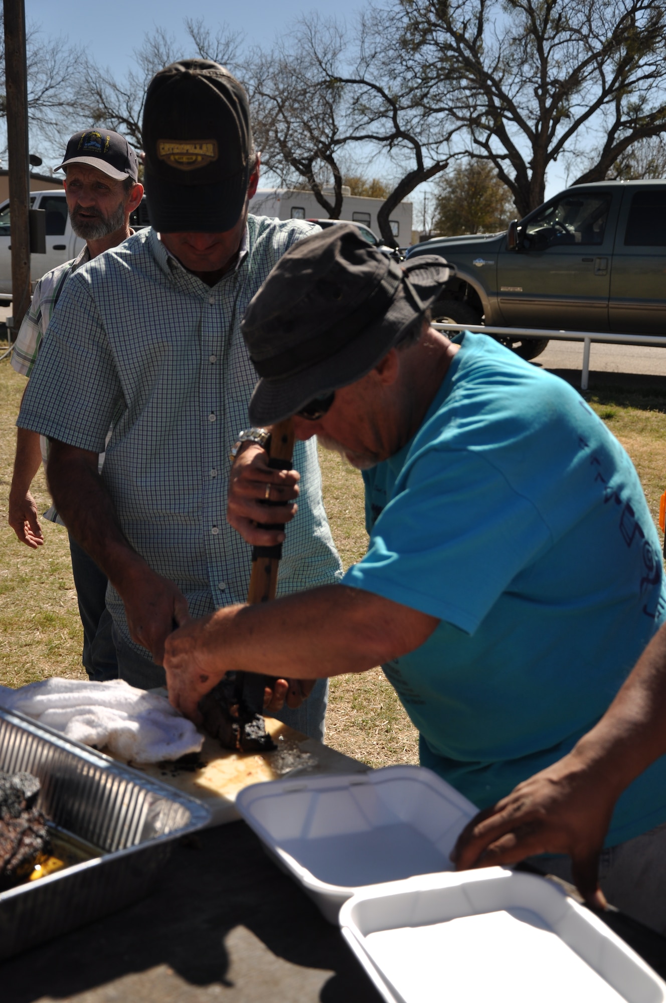 SAN ANGELO, Texas – Jody Darnell and Greg Lancaster, brisket cook-off competitors, prepare their brisket before the turn-in time for the Third Annual Basewide Brisket Cook-Off at the Goodfellow Recreation Camp here March 16.  Besides brisket, the team also cooked ribs and sausage. (U.S. Air Force photo/ Airman 1st Class Joshua Edwards)