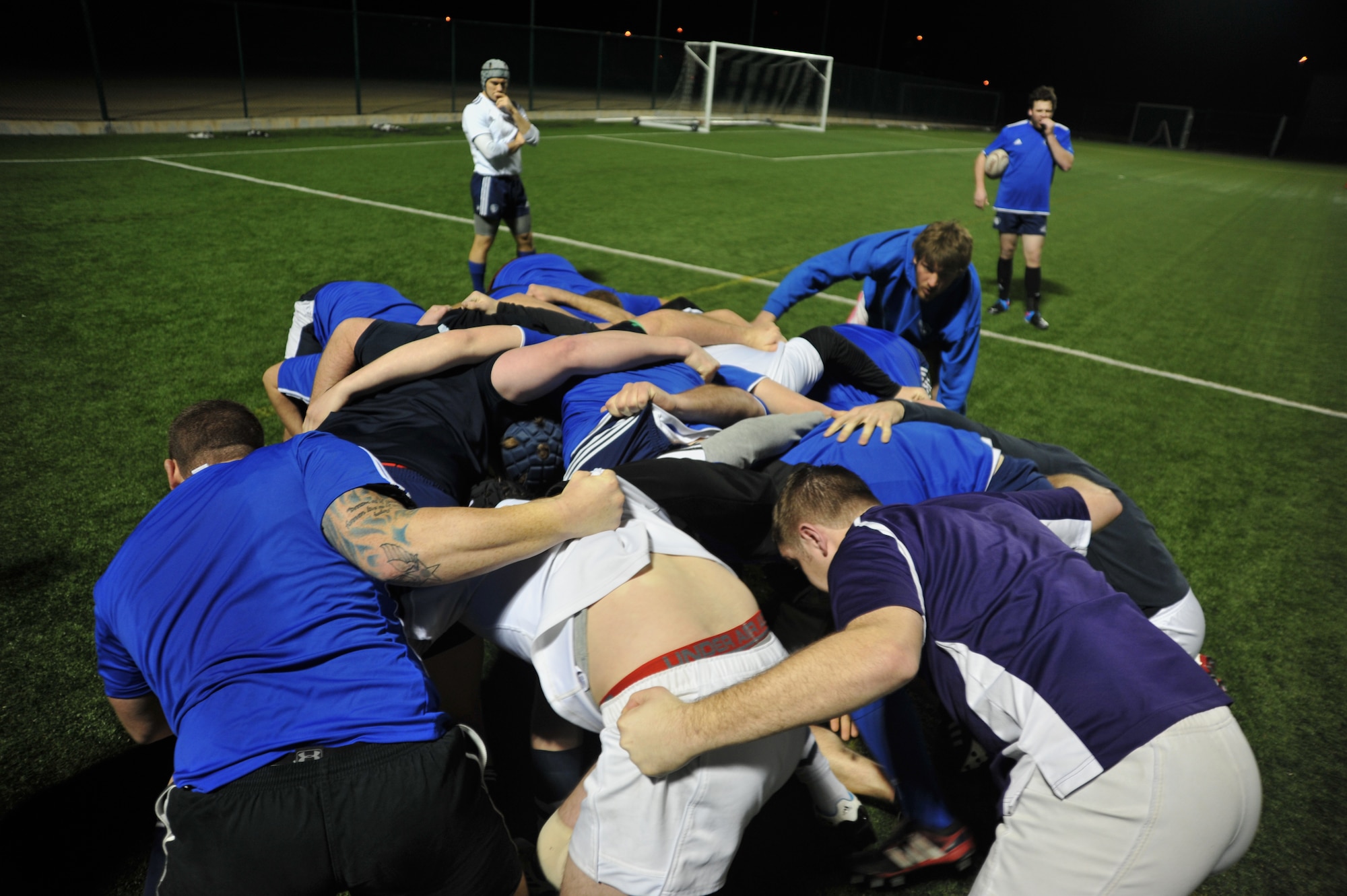 The Kansas City Blues Rugby Club, the only professionally-backed rugby sporting club in America, works on their “scrum” technique during practice in Kansas City, Mo., March 14, 2013. During a scrum, the eight most powerful players from each team collide with each other and battle for the ball on the command of a referee. (U.S. Air Force photo by Senior Airman Brigitte N. Brantley/Released)