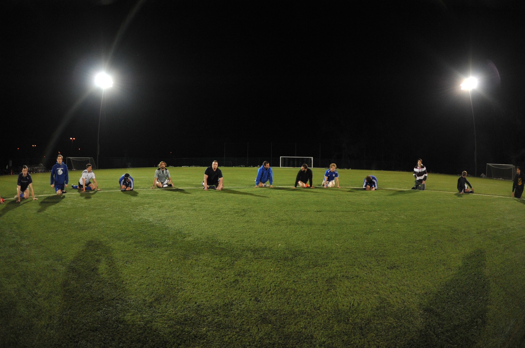 The Kansas City Blues Rugby Club cools down after a two-hour practice in Kansas City, Mo., March 14, 2013. Two days later, they crushed the University of Kansas Jayhawks 66-5. (U.S. Air Force photo by Senior Airman Brigitte N. Brantley/Released)