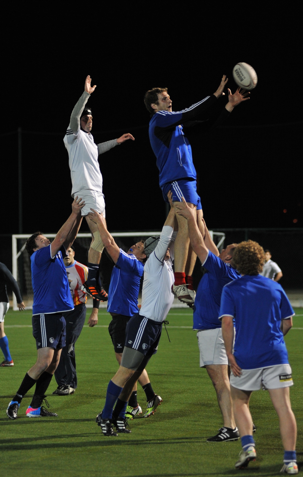 Kevin Schwartze, Kansas City Blues Rugby Club player, catches the ball while being supported by teammates during a line-out while practicing in Kansas City, Mo., March 14, 2013. Equivalent to a soccer throw-in, line-outs happen when a player takes the ball out of the field of play. (U.S. Air Force photo by Senior Airman Brigitte N. Brantley/Released)