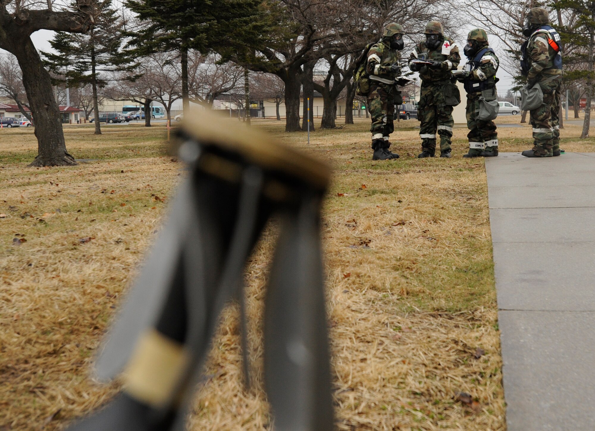 Airmen from the 35th Fighter Wing perform a post attack reconnaissance sweep after receiving simulated indirect fire during an exercise at Misawa Air Base, Japan, March 20, 2013. Airmen conducting the sweep were instructed to identify unexploded ordnances and evaluate M-8 chemical detection paper. (U.S. Air Force photo by Airman 1st Class Kenna Jackson) 