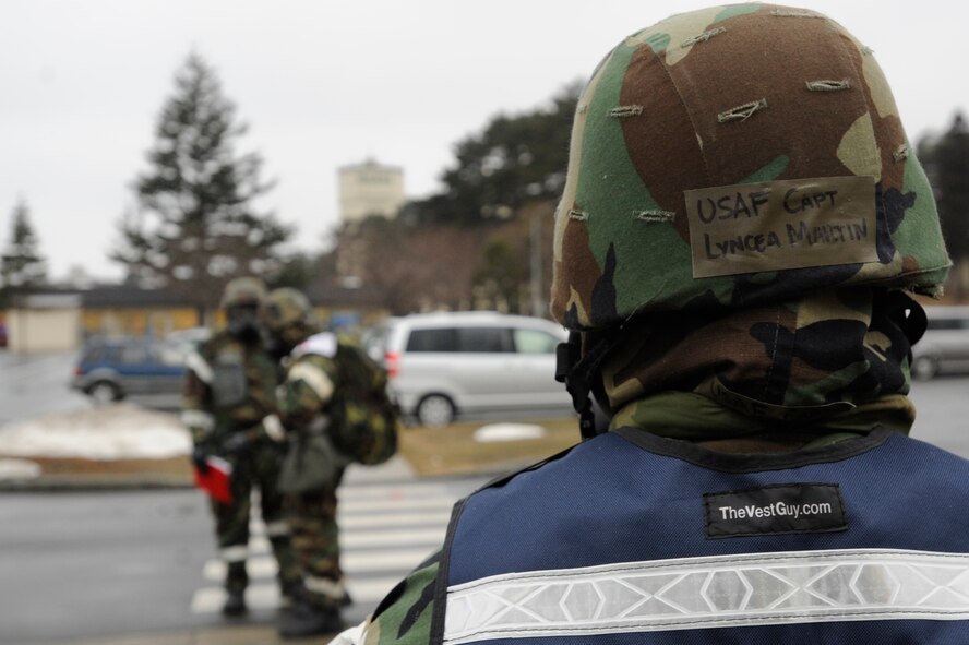 Capt. Lyncea Martin, 35th Mission Support Group, oversees Airmen as they perform a post attack reconnaissance sweep during an Operational Readiness Exercise at Misawa Air Base, Japan, March 20, 2013. This portion of the week-long exercise included multiple simulated indirect fire attacks. During the sweep, Airmen were required to identify unexploded ordnances and evaluate M-8 chemical detection paper. (U.S. Air Force photo by Airman 1st Class Kenna Jackson)