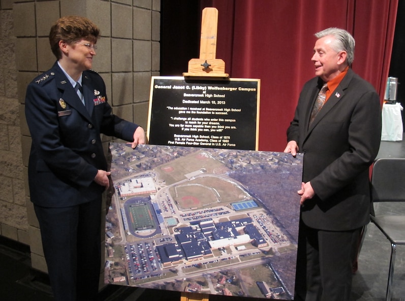 Gen. Janet Wolfenbarger, Air Force Materiel Command commander, accepts a photograph of the newly renamed “General Janet C. (Libby) Wolfenbarger Campus at Beavercreek High School” from Beavercreek City Schools superintendent Bill McGlothlin during a dedication ceremony March 15. The plaque behind them will be erected at the campus entrance. The plaque reads: "General Janet C. (Libby) Wolfenbarger Campus at Beavercreek High School. Dedicated March 15, 2013. 'The education I received at Beavercreek High School gave me the foundation to succeed. I challenge all students who enter this campus to reach for your dreams. You are far more capable than you think you are. If you think you can, you will.' Beavercreek High School, Class of 1976. U.S. Air Force Academy, Class of 1980. First Female Four-Star General in the U.S. Air Force." (U.S. Air Force photo/Ron Fry)