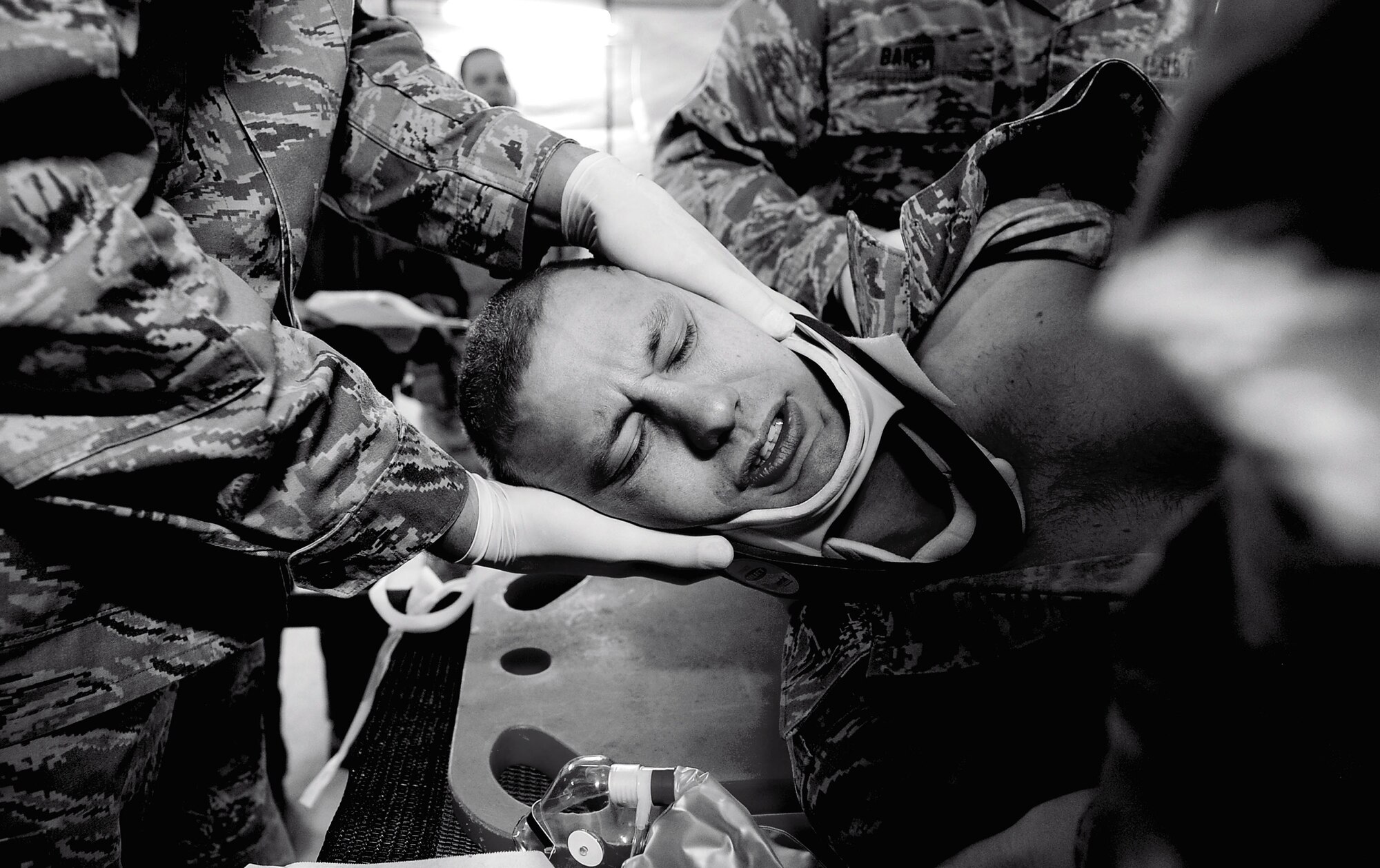 A simulated patient is turned on his side by medical technicians and doctors from the 121st Medical Group as part of a training scenario at Suwon Air Base, Republic of Korea, Feb. 19, 2013. (U.S. Air Force photo by Staff Sgt. Sara Csurilla)