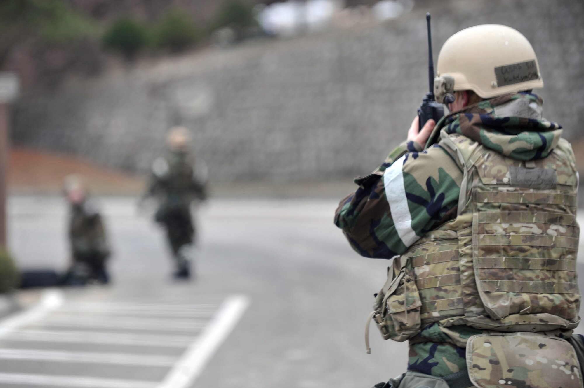 Senior Airman Katelyn Crosby, 51st Civil Engineer Squadron Explosive Ordnance Disposal journeyman, coordinates with her team for the detonation of a simulated 16 millimeter mortar for removal during Operational Readiness Exercise Beverly Midnight 13-02 outside Bldg. 839 at Osan Air Base, Republic of Korea, March 20, 2013. Osan participates in these exercises so Airmen can demonstrate their capabilities and ability to perform in heightened awareness situations. (U.S. Air Force photo/Senior Airman Alexis Siekert)