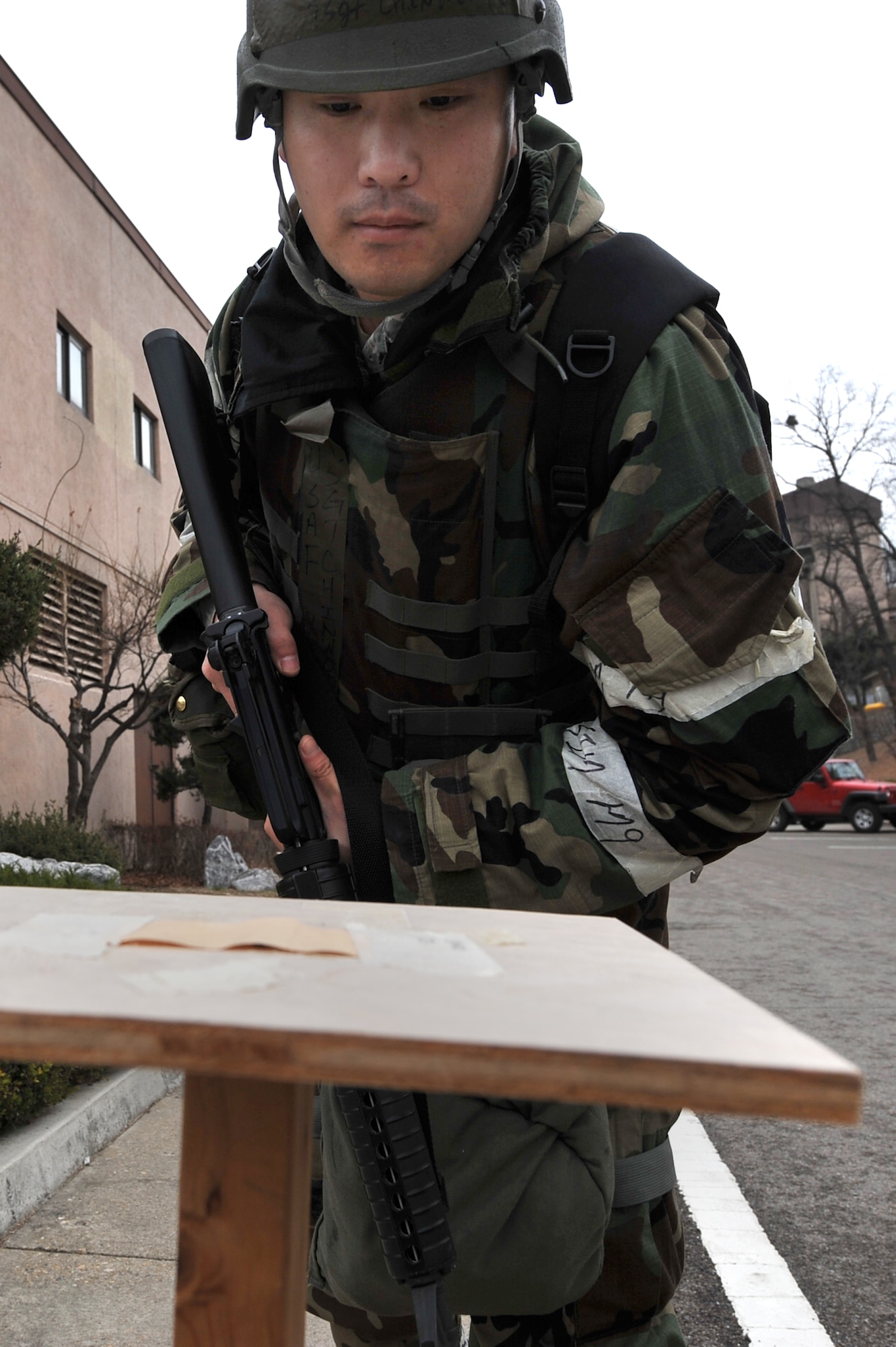 Tech. Sgt. Chinwoo Mun, 51st Comptrollers Squadron budget analysis, checks M-8 paper for contaminates during a post attack reconnaissance sweep outside Bldg. 839 during Operational Readiness Exercise Beverly Midnight 13-02 at Osan Air Base, Republic of Korea, March 20, 2013. Scenarios like these give Airmen a chance to hone wartime skills in a safe and structured environment in preparation for real-world contingencies. (U.S. Air Force photo/Senior Airman Alexis Siekert)
