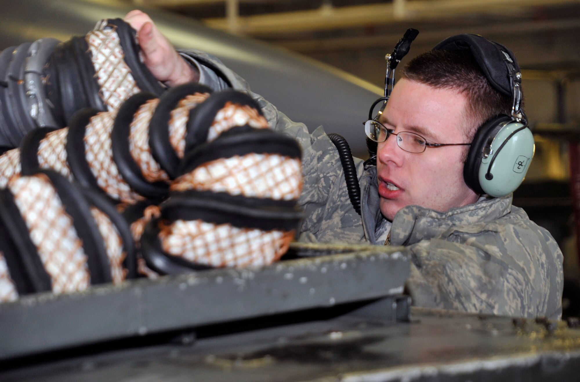 U.S. Air Force Staff Sgt. Michael Hill, 14th Aircraft Maintenance Unit avionics technician, puts away a Bleed Air Hose after generating aircraft during a wing Operational Readiness Exercise at Misawa Air Base, Japan, March 18, 2013. During this exercise, the AMUs came together to achieve their goal of generating safe and reliable aircraft, which helped demonstrate the wing's overall readiness. (U.S. Air Force photo by Airman 1st Class Zachary Kee)