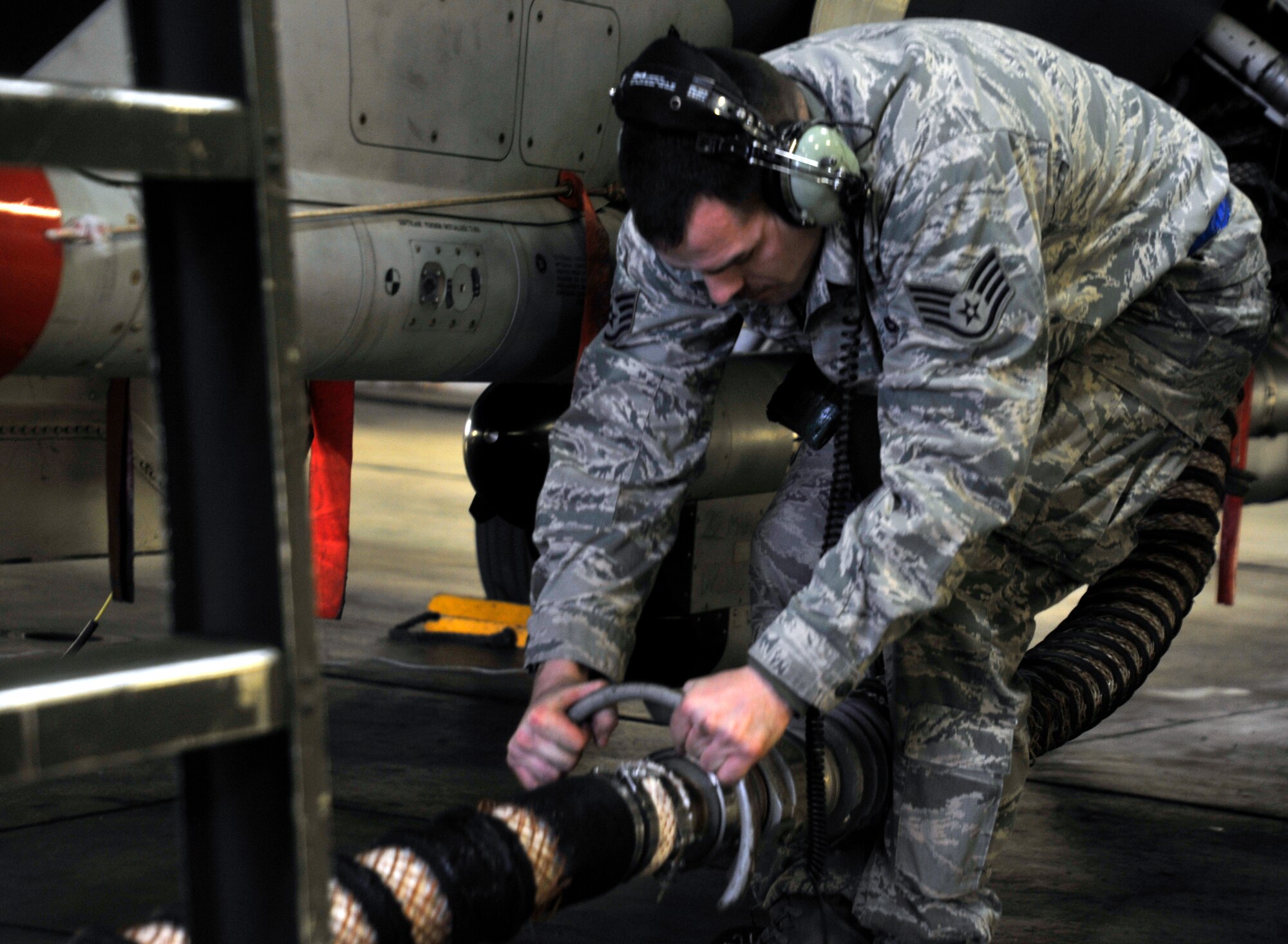 U.S. Air Force Staff Sgt. Michael Scott, 13th Aircraft Maintenance Unit avionics technician, connects an Equipment Cooling Set hose with a Bleed Air hose during aircraft generation at Misawa Air Base, Japan, March 18, 2013. The wing’s AMUs were tasked with multiple aircraft generations, which were to be done in less than 24 hours. (U.S. Air Force photo by Airman 1st Class Zachary Kee)