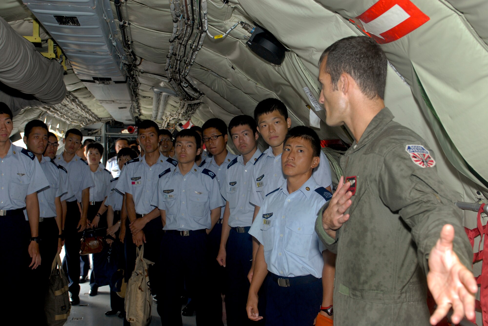 U.S. Air Force Staff Sgt. Brian Porter, 909th Air Refueling Squadron in-flight refueler, shows the inside of a KC-135 Stratotanker refueling aircraft to cadets from the Air Officer School in Nara Prefecture on Kadena Air Base, Japan, July 19, 2012. The 909th ARS recently won the Senior Master Sgt. Albert L. Evans Outstanding Air Refueling Section of the Year Award at the Pacific Air Forces level for 2012. (U.S. Air Force photo/Airman 1st Class Malia Jenkins)

