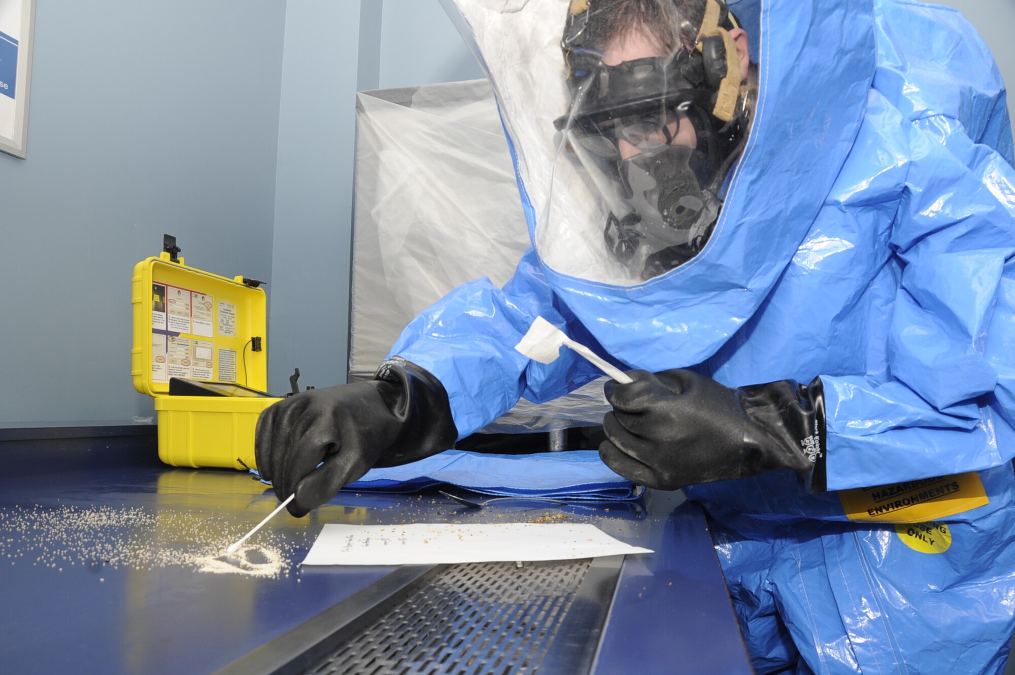 U.S. Air Force Airman 1st Class Joshua Daggett, 35th Civil Engineer Squadron exercise craftsman, takes samples of simulated biological hazards found at the Richard Bong Theater during the first day of the operational readiness exercise at Misawa Air Base, Japan, March 18, 2013. The exercise tested the wing's response to hazardous material incidents. (U.S. Air Force photo by Airman 1st Class Kenna Jackson)