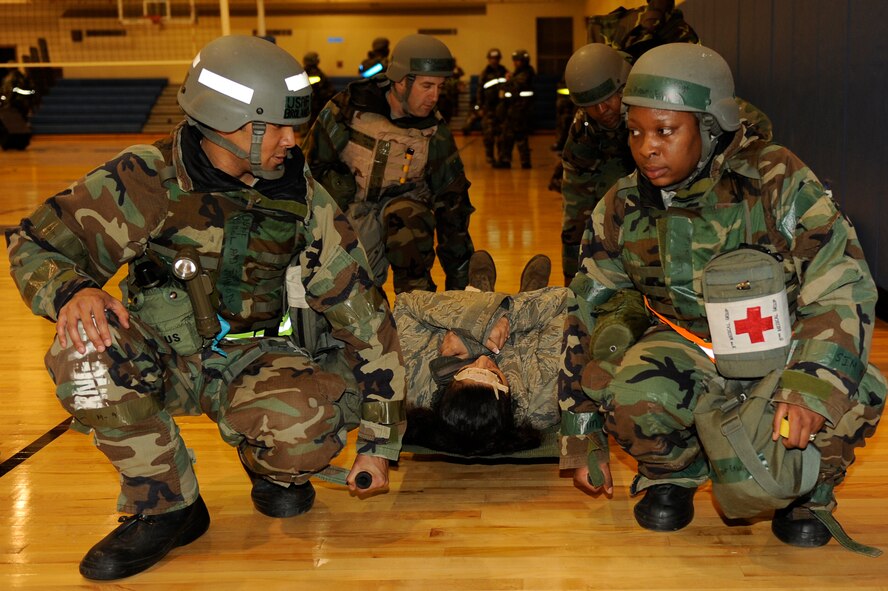 Airmen from the 8th Medical Group lower a simulated patient to the ground during exercise Beverly Midnight 13-2 at Kunsan Air Base, Republic of Korea, March 19, 2013. The medical group set up operations in the fitness center after a scenario  damaged their primary work center. (U.S. Air Force photo by Senior Airman Marcus Morris/Released)