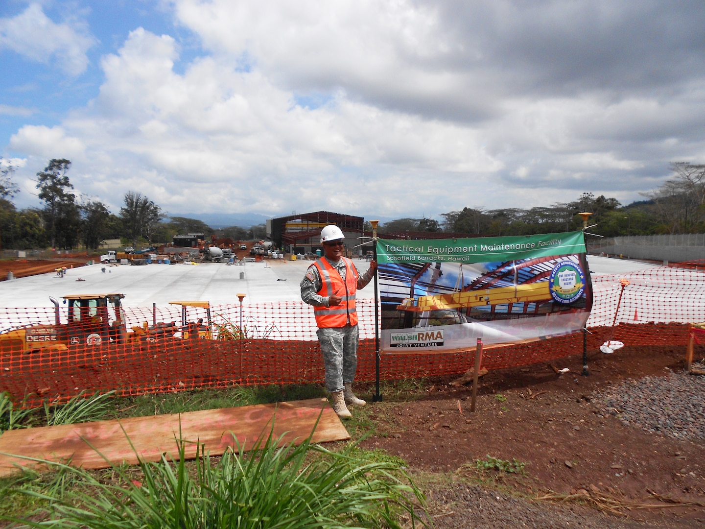 U.S. Army Spec. Dave Balisican stands in front of the $38 million Tactical Equipment Maintenance Facility project site at Schofield Barracks where he worked with District project engineers and managers as part of the quality assurance team.