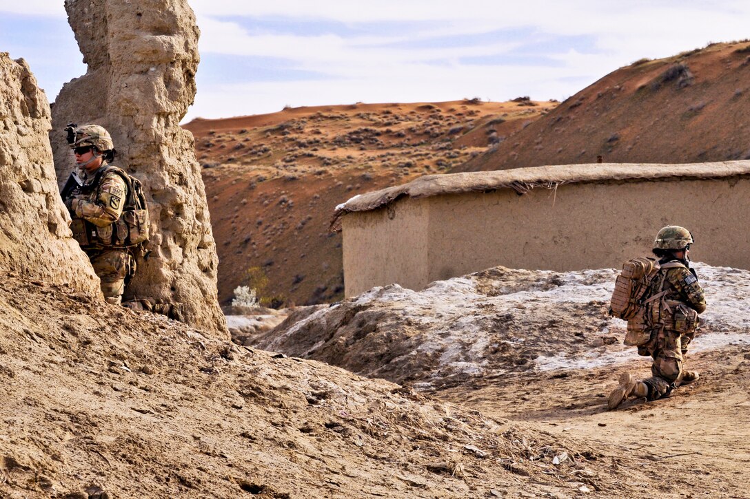 U.S. female soldiers secure an Afghan compound while other soldiers meet with Afghan elders in the Spin Boldak district in Afghanistan's Kandahar province, March 3, 2013. The soldiers are assigned to the 2nd Infantry Division's Female Engagement Team 6, 2nd Battalion, 23rd Infantry Regiment, and 519th Military Intelligence Battalion. 