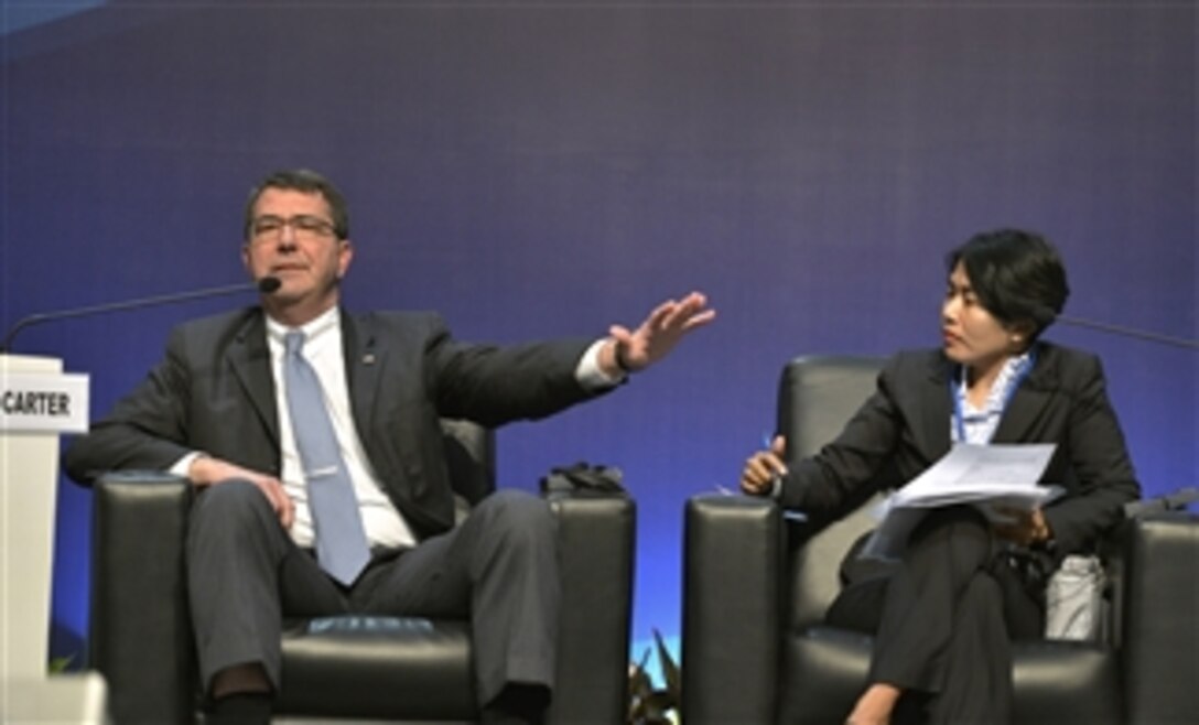 Deputy Secretary of Defense Ashton B. Carter, left, participates in a panel discussion titled "Rise of Asia and the New Geopolitics in the Asia-Pacific Region" while attending the Jakarta International Defense Dialogue in Jakarta, Indonesia, on March 20, 2013.  The panel discussion was moderated by Desi Anwar, right.  