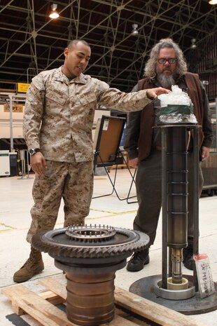 Cpl. Raffeal Ahamad, a Marine Aviation Logistics Squadron 12 collateral duty inspector, discusses components that make up a General Electric F404 engine with Mark Boone Junior, “Sons of Anarchy” television star, at the MALS-12 power plant here March 14, as part of the 2013 USO Handshake Tour. Fellow SOA alum, Kim Coates and Dayton Collie were also in attendance. The stars also visited with Marine Wing Support Squadron 171 servicemembers and signed autographs and posed for pictures at the Marine Corps Exchange. The trio closed out this portion of the tour by signing more autographs at the Hornet’s nest later that evening.