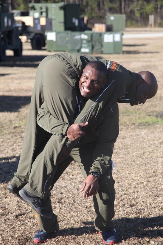 Master Sgt. Herbert Smith, staff noncommissioned officer in charge of the Marine Air Control Squadron 2 tactical air operations center detachment, conducts buddy squats March 15 during a squadron-wide High Intensity Tactical Training class.