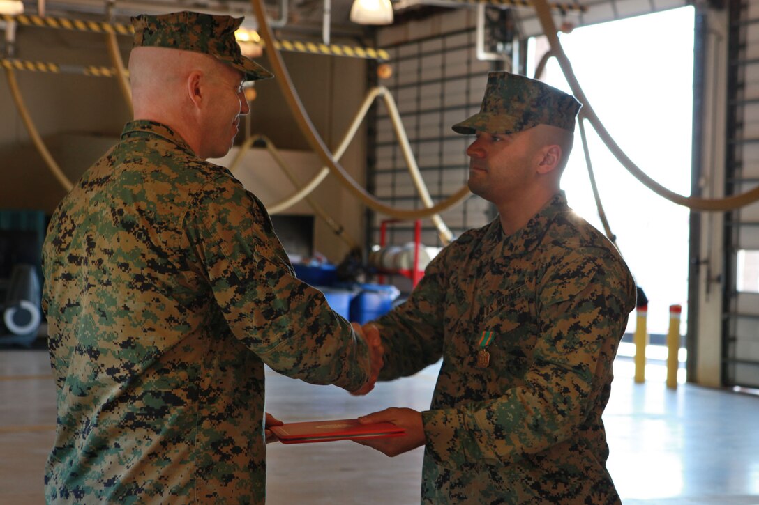 Sgt. Fernando Camacho, Headquarters and Headquarters Squadron aircraft rescue and firefighting Marine, receives a Navy and Marine Corps Achievement Medal with combat distinguishing device, March 4. Camancho was awarded the medal for his actions during an assault on Camp Bastion, Afghanistan. 
