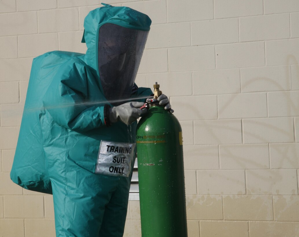 A Chemical, Biological, Radiological and Nuclear defense specialist with Marine Wing Headquarters Squadron 2 attempts to stop a leak on a release cylinder aboard Cherry Point March 13.
