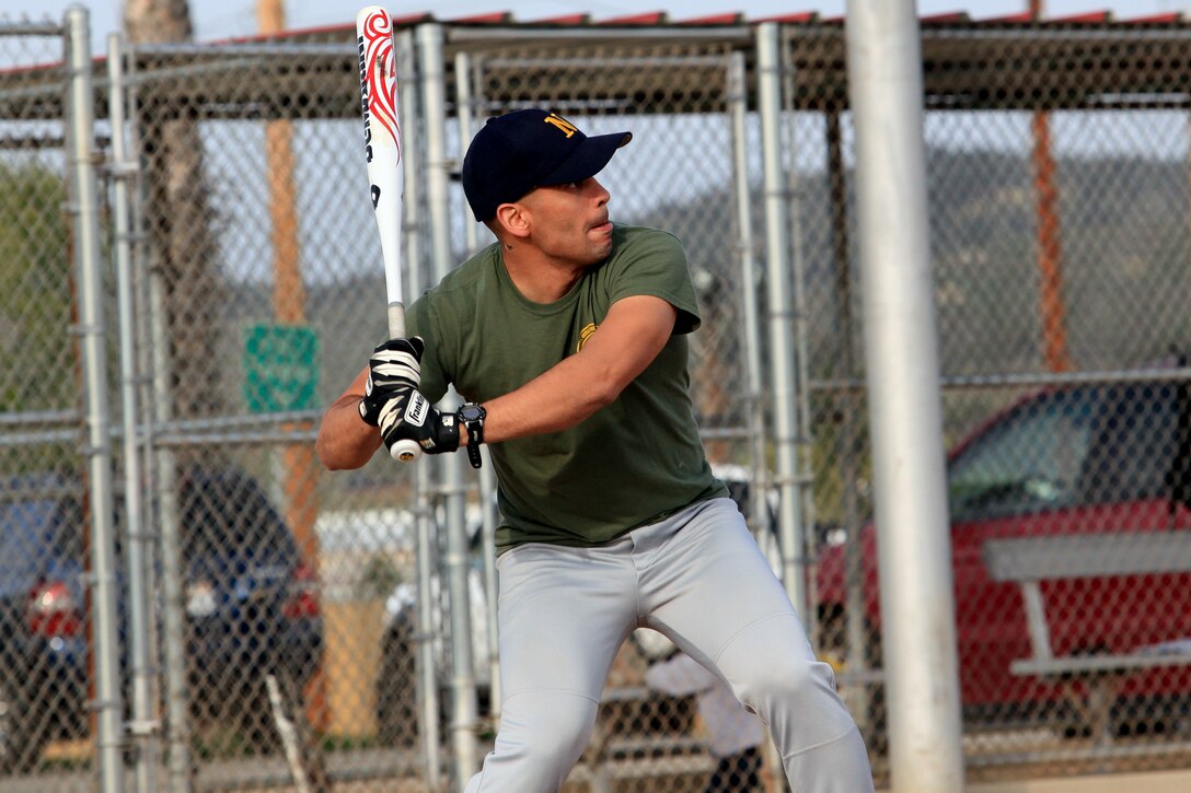Maj. Wilfredo Crave, the commanding officer of headquarters company, 1st Intelligence Battalion, from San Juan, Puerto Rico, concentrates on the ball coming his way as he tries to help his team with their first regular season softball game at Camp Pendleton, Calif., March 19. The softball games are part of a competition known as the Commanding General's Cup. The cup has 23 events and allows Marines an opportunity to develop unit cohesion through competition outside of the work area.