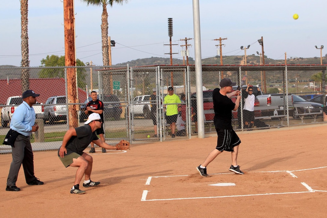 Lance Cpl. Anthony Johnson, a ground support equipment representative with Marine Medium Helicopter Squadron 268, from Phoenix, hits a ball deep into left field in his team's first regular season softball game at Camp Pendleton, Calif., March 19. The softball games are part of a competition known as the Commanding General's Cup. The cup has 23 events and allows Marines an opportunity to develop unit cohesion through competition outside of the work area.