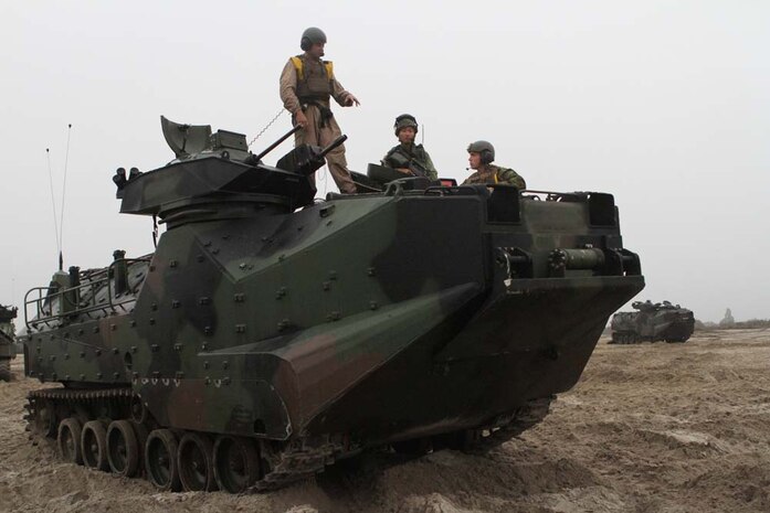 Marines serving with 3rd Assault Amphibian Battalion explain the capabilities of assault amphibious vehicles to Capt. Bernard Tay, a company commander serving with 3rd Battalion Singapore Guards, before conducting amphibious assault training during Exercise Valiant Mark. Aging weapons systems such as the AAV are more likely to incur supplier items or raw material shortages that the proactive Diminishing Manufacturing Sources and Material Shortages program is designed to address. 