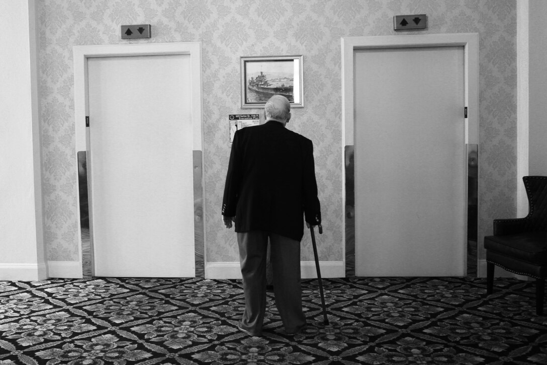 A WWII veteran awaits an elevator at the Marines' Memorial Club and Hotel library in San Francisco March 13, 2013. He was there to celebrate the 68th Anniversary of the Battle of Iwo Jima with a luncheon ceremony. The event was also an opportunity to accentuate the connection between the WWII-era 4th Marine Division with today's 4th Marine Division. More than 100 veterans, modern Marines and guests were in attendance. 