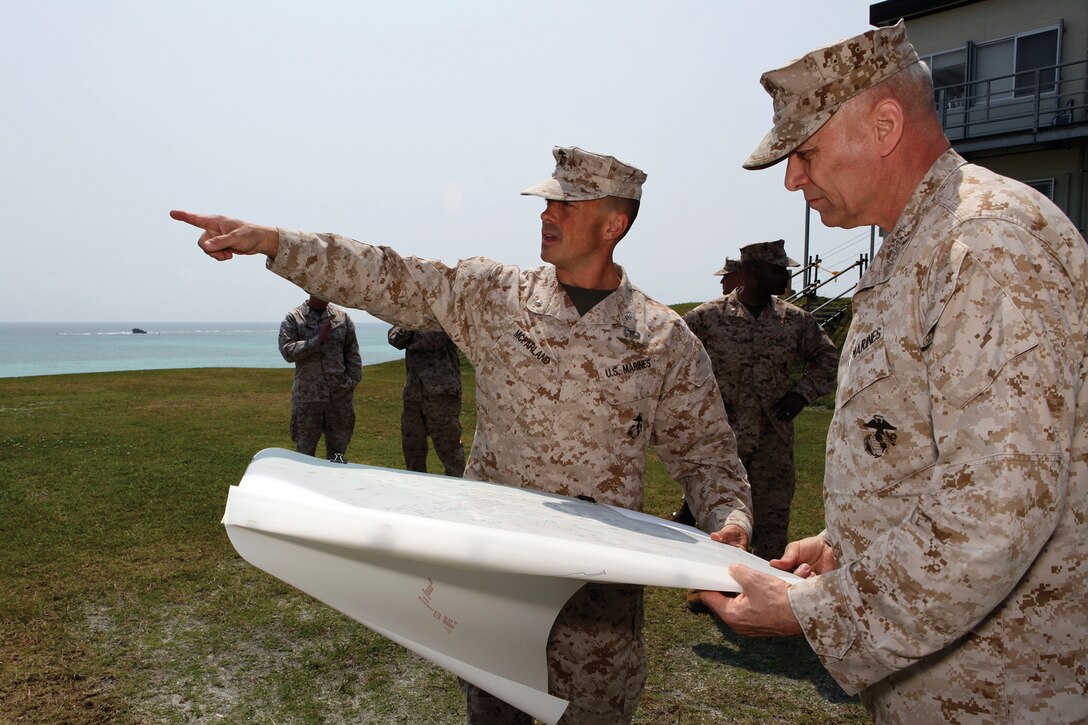 Lt. Col. Jason S. McFarland indicates where the future location of the Futenma Replacement Facility will be to Assistant Commandant of the Marine Corps Gen. John M. Paxton Jr. March 19 at Camp Schwab. During his visit to Okinawa, Paxton received updates from key leaders on facilities throughout the island, including the new U.S. Naval Hospital Okinawa location on Camp Foster and the FRF. McFarland is the FRF project management officer with G-F, Facilities, Marine Corps Base Camp Smedley D. Butler.