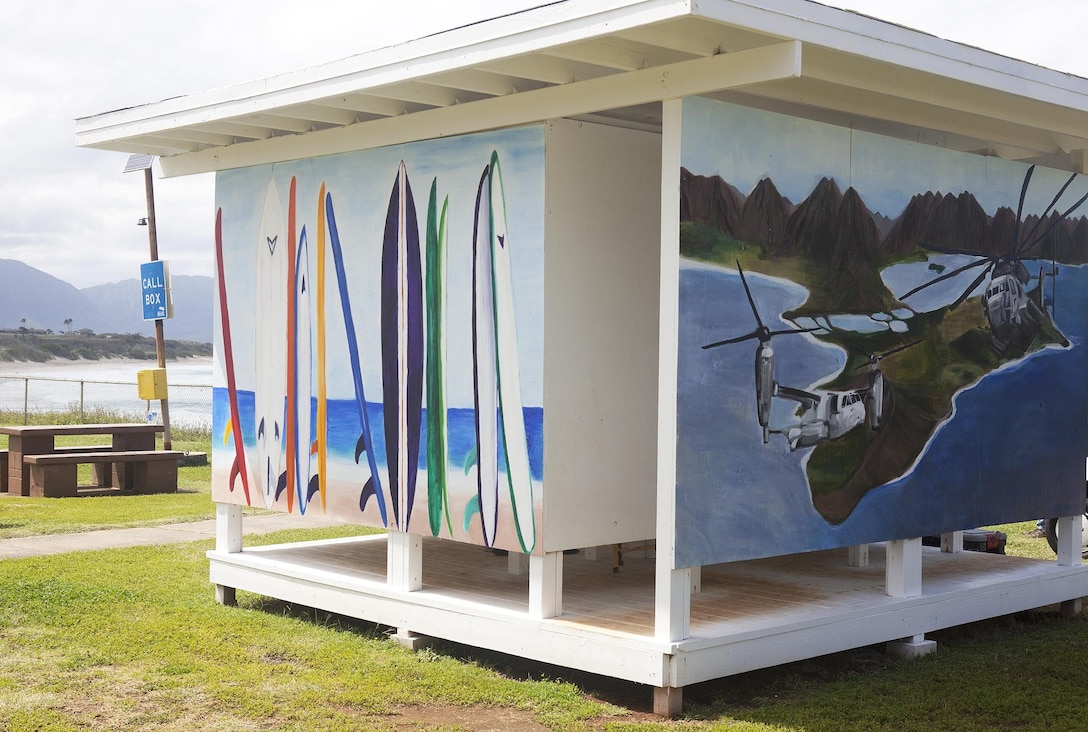MARINE CORPS BASE HAWAII - A helicopter and surfboard painting by Sarah Mathos decorates the sides of the newly-built changing station located at North Beach, Marine Corps Base Hawaii, March 13, 2013. The changing station was constructed to provide surfers and beachgoers a place to shower and change after spending the day on the beautiful stretch of North Beach. (U.S. Marine Corps photo by Lance Cpl. Suzanna Lapi)

