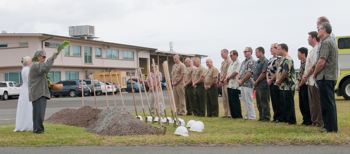 MARINE CORPS BASE HAWAII - Nalani Olds (left) and Kahu Likeke Papa perform a Hawaiian blessing during the groundbreaking ceremony for the Marine Corps Air Station Operations Complex, near the Aircraft Rescue and Firefighting building, March 15, 2013. The $46.6 million project includes a new terminal operations building, an ARFF building with individual dormitories for ARFF Marines, bays for fire trucks and office spaces. The complex is scheduled for completion in September 2014. (U.S. Marine Corps photo by Kristen Wong)