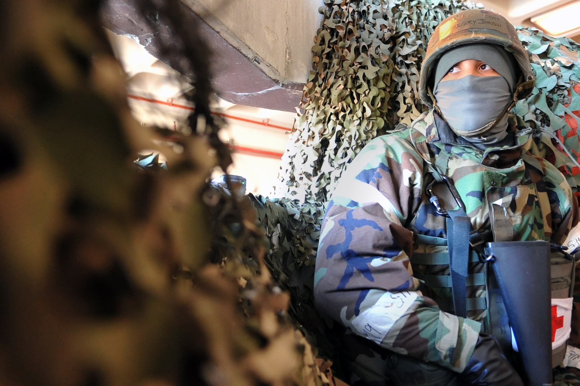 Staff Sgt. Gregory Johnson, 51st Medical Squadron dental technician base augmentee, stands guard outside the medical group emergency entrance during a training scenario at Osan Air Base, Republic of Korea, March 21, 2013. These types of training scenarios are a part of Operational Readiness Exercise Beverly Midnight 13-02 that help Airmen sharpen their skills in case of a real world contingency. (U.S. Air Force photo/Senior Airman Alexis Siekert) 