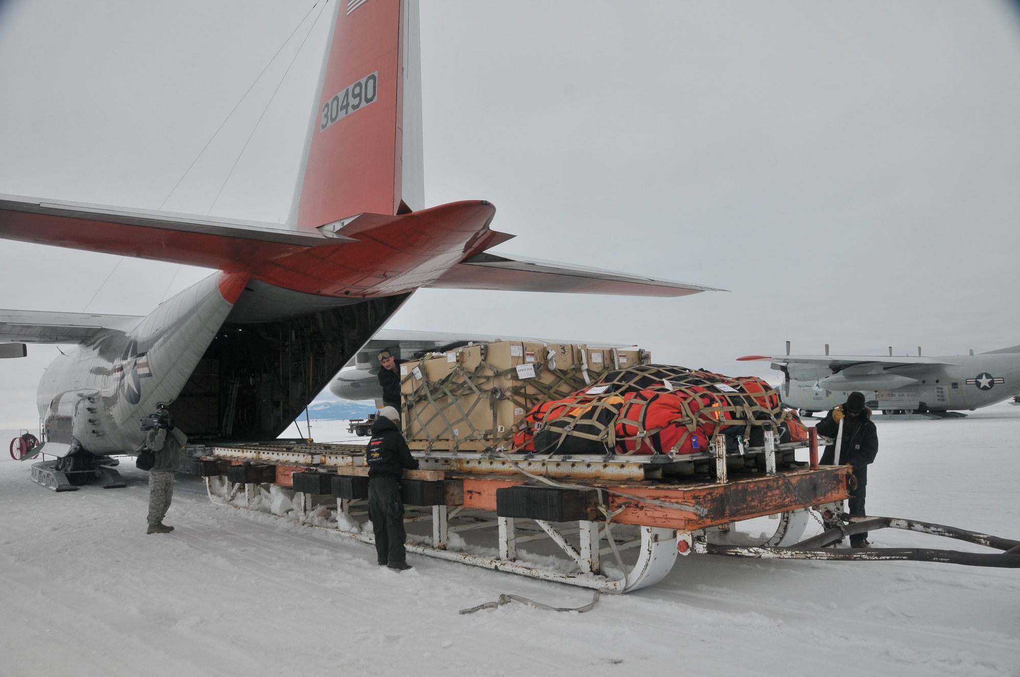 Civilian personnel work side by side with military members from the 109th Airlift Wing at McMurdo Station, Antarctica on December 15th 2012, as they load cargo onto an LC-130 Skibird bound for remote camps. (USAF Photo by SrA Ben German/Released)