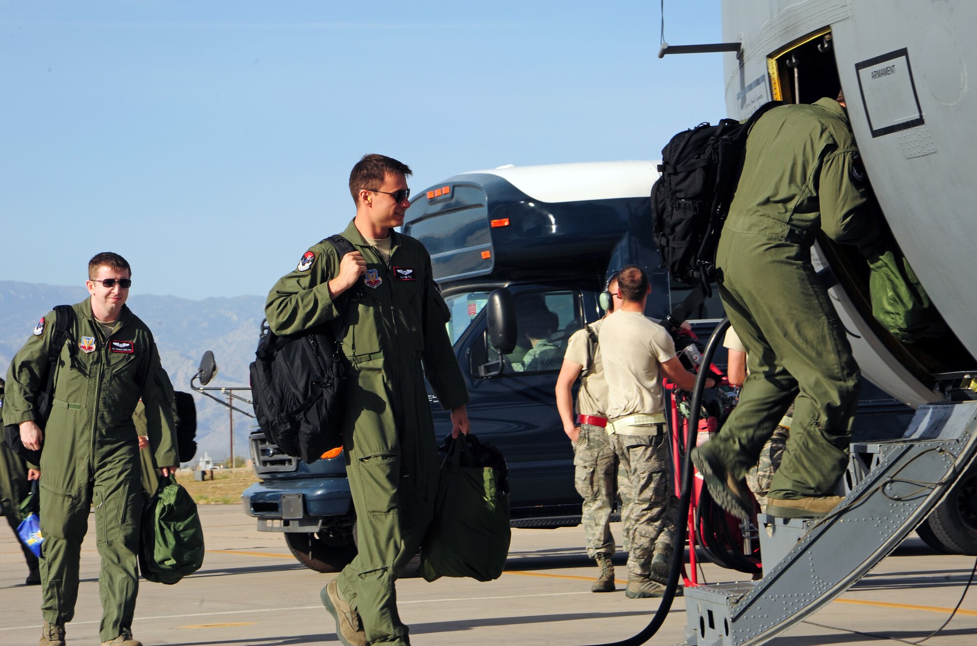 Members of the 43rd Electronic Combat Squadron step to a EC-130H Compass Call at Davis-Monthan Air Force Base, Ariz., March 20, 2013. Aircrew will typically step an hour before takeoff, as it takes time to run checklists, start engines and taxi. (U.S. Air Force photo by Senior Airman Camilla Griffin/Released)
