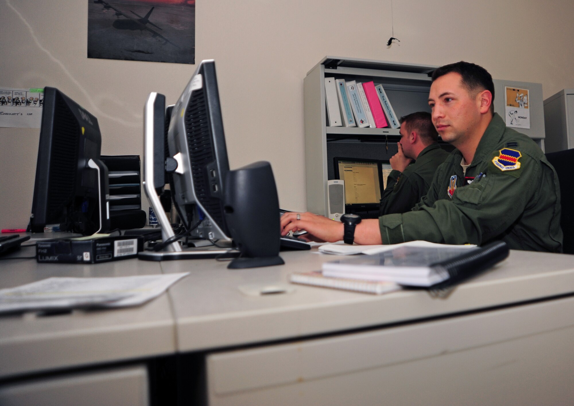 U.S. Air Force Capt. Luis Pena, 43rd Electronic Combat Squadron EC-130H Compass Call pilot, processes a officer performance report at Davis-Monthan Air Force Base, Ariz., March 20, 2013. When not flying, Pena processes OPRs and other administrative paperwork. (U.S. Air Force photo by Senior Airman Camilla Griffin/Released)