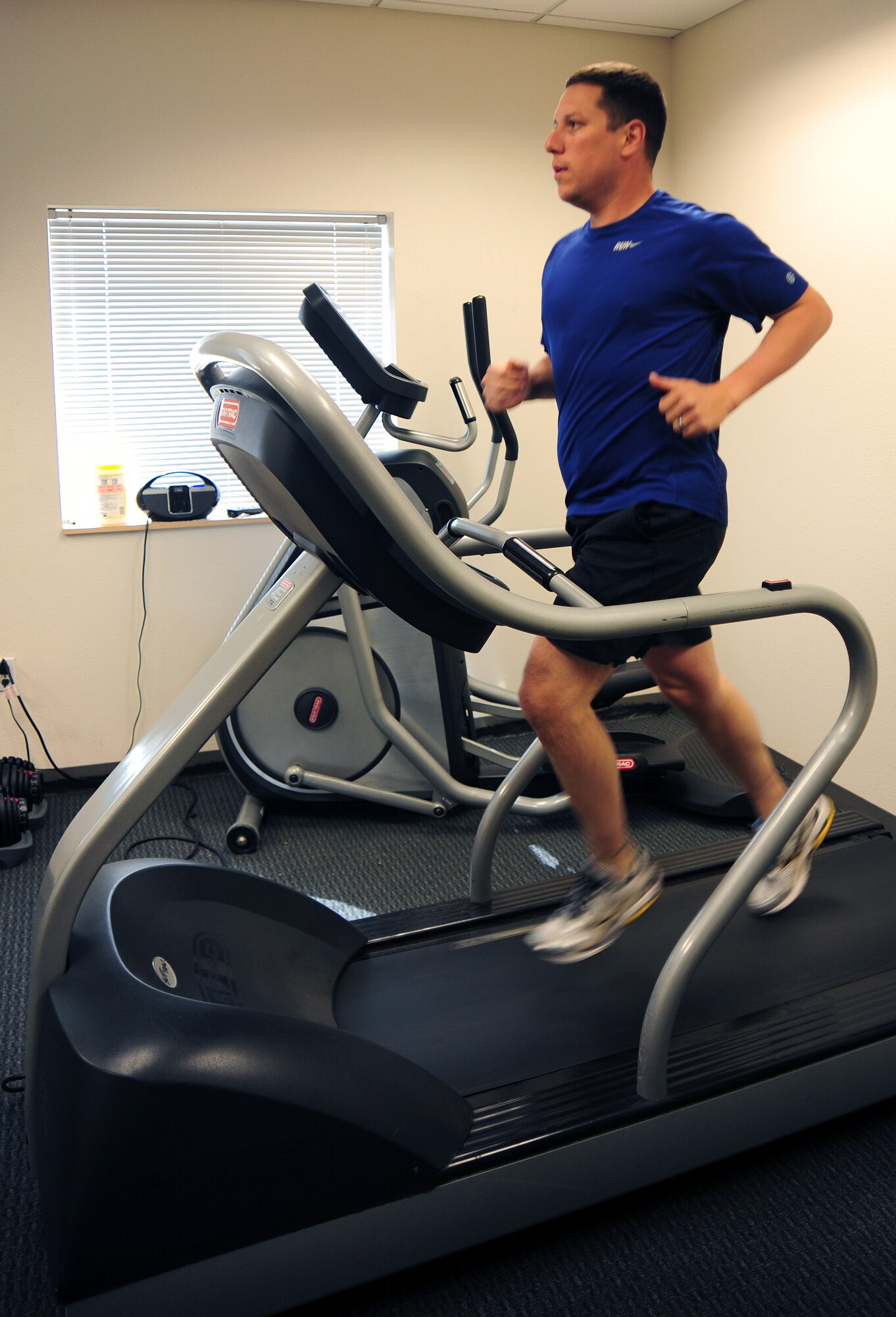 U.S. Air Force Maj. Michael Padilla, 43rd Electronic Combat Squadron assistant director of operations, warms up on a treadmill before going for a run at Davis-Monthan Air Force Base, Ariz., March 20, 2013. The 43rd ECS has a mandatory physical training session every Thursday morning because of their flying operations and continued mission related obligations, they are encouraged to PT regularly throughout the week. (U.S. Air Force photo by Senior Airman Camilla Griffin/Released)