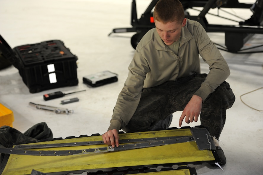 Airman 1st Class Kelby Baldwin, 28th Aircraft Maintenance Squadron crew chief, organizes panels in preparation of a Non-Destructive Inspection during a recent Operational Readiness Exercise at Ellsworth Air Force Base, S.D., March 19, 2013. The ORE was designed to test the base’s ability to mobilize, process personnel and equipment, and simulate deploying in response to a worldwide tasking. (U.S. Air Force photo by Airman 1st Class Hrair H. Palyan/Released)