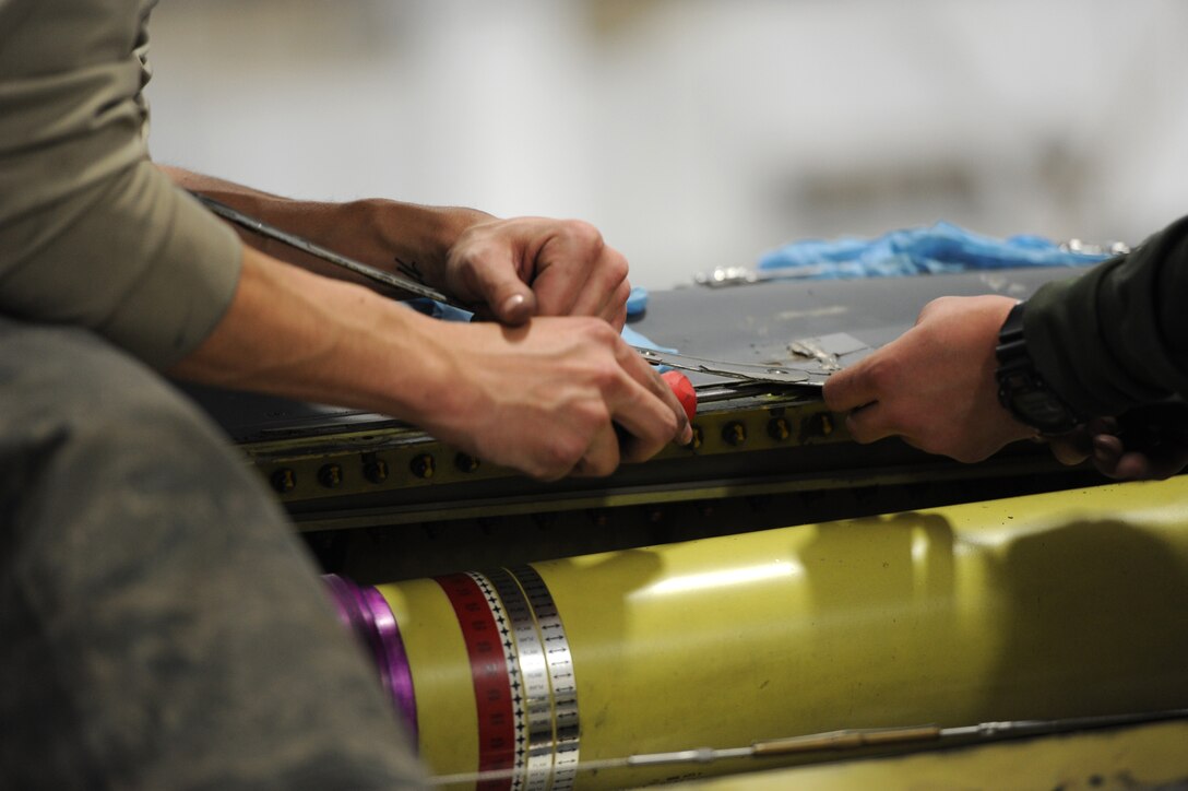 Airman 1st Class Justin Rule (left) and Senior Airman Bobby Haworth, 28th Aircraft Maintenance Squadron crew chiefs, pry off panels from a B-1 for a Non-Destructive Inspection during the recent Operational Readiness Exercise at Ellsworth Air Force Base, S.D., March 19, 2013. The ORE covered a variety of B-1B operations, including aircraft maintenance and support functions. (U.S. Air Force photo by Airman 1st Class Hrair H. Palyan/Released)