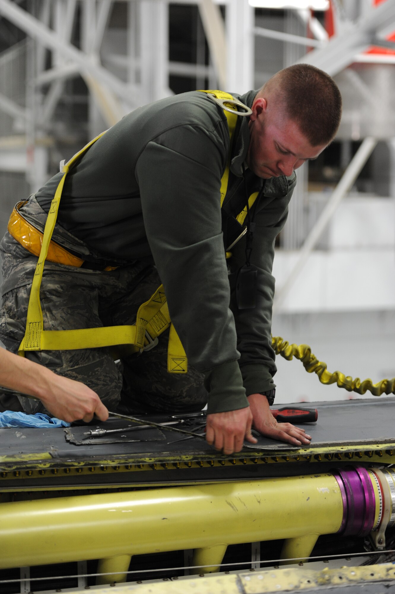 Senior Airman Bobby Haworth, 28th Aircraft Maintenance Squadron crew chief, removes panels from a B-1 for a Non-Destructive Inspection during the recent Operational Readiness Exercise at Ellsworth Air Force Base, S.D., March 19, 2013. Airmen in a variety of non-aviation roles conducted a broad range of active, hands-on training spanning a myriad of tasks to ensure the success of B-1 missions. (U.S. Air Force photo by Airman 1st Class Hrair H. Palyan/Released)