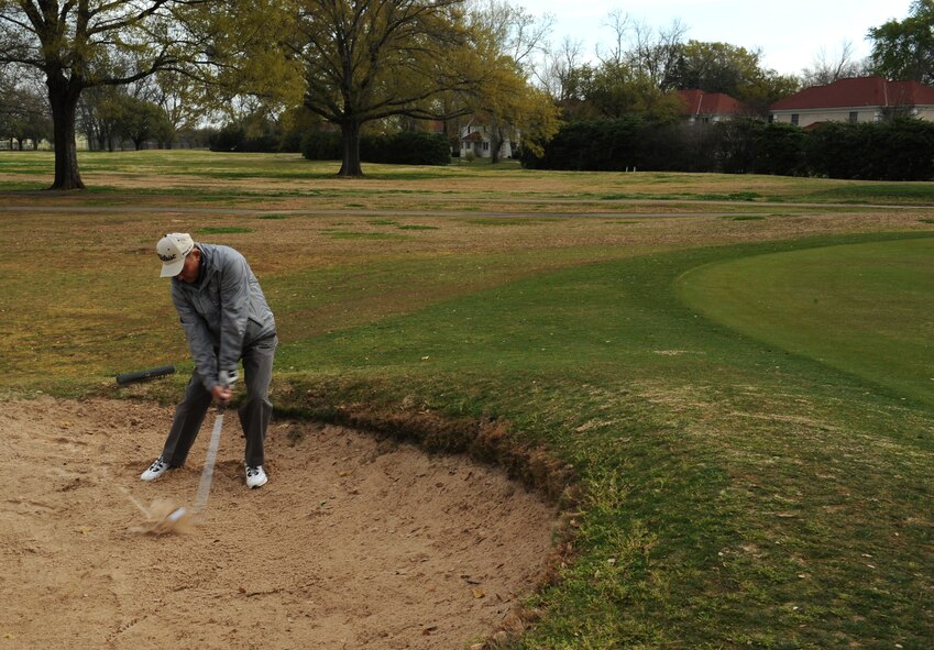 Bill Bohringer hits a golf ball out of a sand pit at the Fox Run Golf Course on Barksdale Air Force Base, La., March 21. Bohringer is a retired U.S. Army major who was an U.S. Army Parachute Team "Golden Knights" jumper and pilot. The golf course offers a driving range and hosts tournaments for base organizations. (U.S. Air Force photo/Airman 1st Class Benjamin Gonsier)

