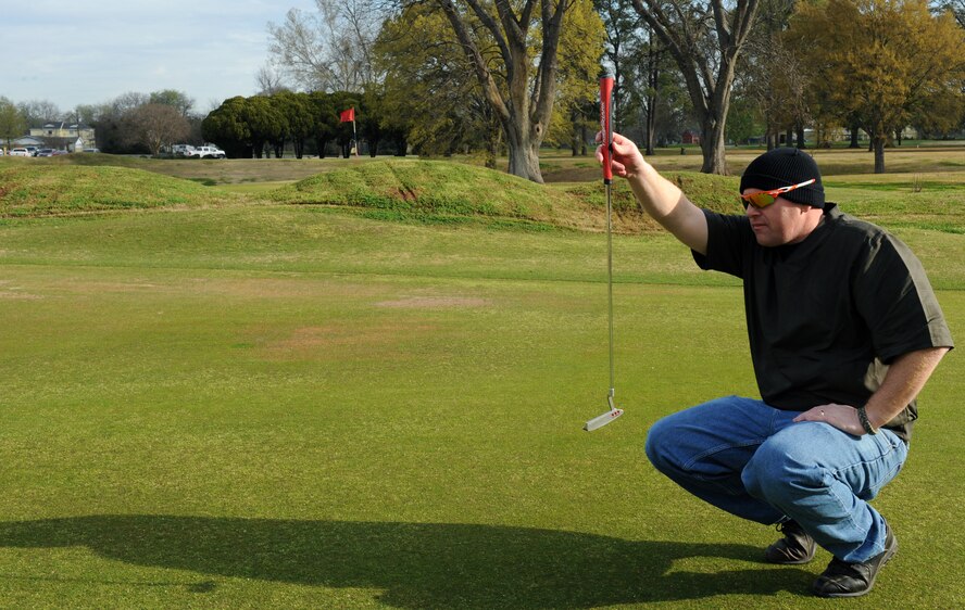 Senior Master Sgt. Jason Price, 2nd Munitions Squadron, lines up a shot before putting at the Fox Run Golf Course on Barksdale Air Force Base, La., March 21. The golf course contains an 18-hole course, driving range and classes for both adults and children. (U.S. Air Force photo/Airman 1st Class Benjamin Gonsier)