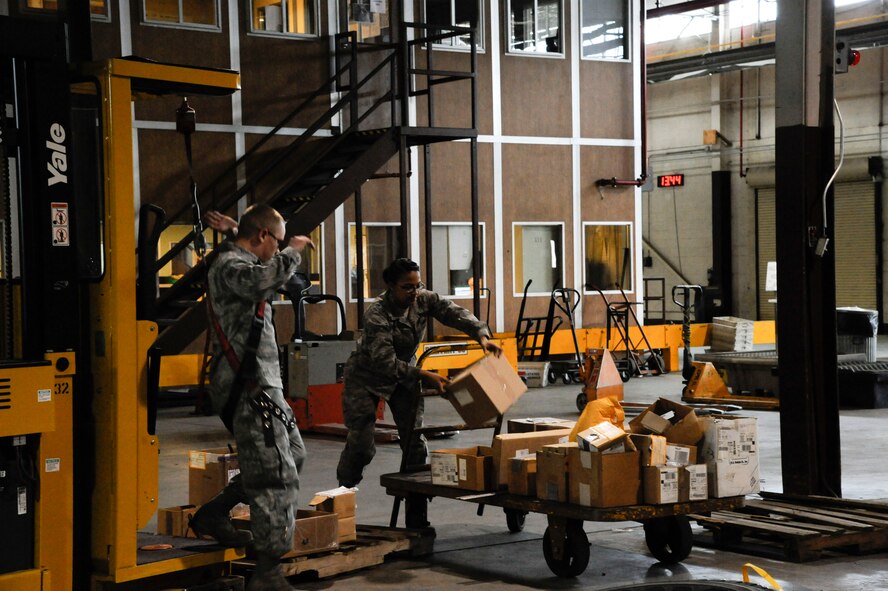 Senior Airman Casey McClelland, 2nd Logistics Readiness Squadron Aircraft Parts Store, and Airman 1st Class Jazmin Rodriguez, 2nd LRS APS, load aircraft parts onto a cart on Barksdale Air Force Base, La., March 21. The Airmen were loading and moving parts from the 2 LRS Material Management flight to consolidate parts into one warehouse. (U.S. Air Force photo/Airman 1st Class Andrew Moua)