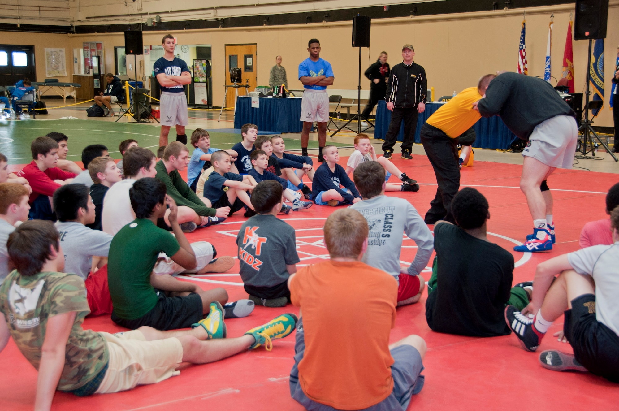 Members of the All-Army wrestling team demonstrate and break down different techniques for more than 45 children, ages six to 18, during a wrestling clinic in Griffith Field House March 16, 2013, on Joint Base McGuire-Dix-Lakehurst, N.J. The Army wrestling team was asked to lead a clinic after the first day of the 2013 Armed Forces Wrestling Championship, having three Olympic wrestlers, and enlisted help from members of the Air Force team. Each attending wrestler watched a group to ensure the children received as much guidance and experience out of the clinic as possible. (U.S. Air Force photo by Airman Tara A. Williamson/Released)