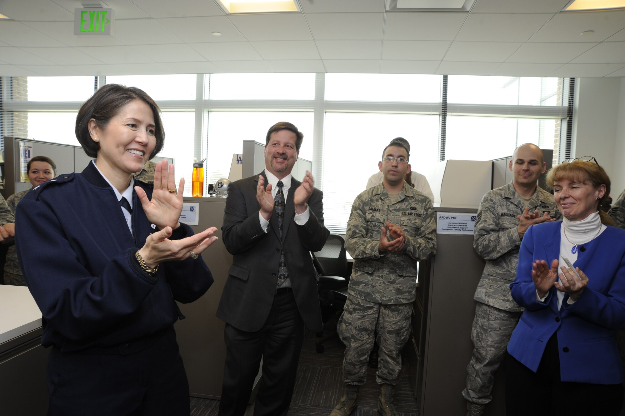 Air Force District of Washington Commander Maj. Gen. Sharon K.G. Dunbar and the AFDW Director of Staff Dean Peebels congratulate Headquarters AFDW Contracting for earning Air Force-level awards March 11, 2013 on Joint Base Andrews, Md. “This team has done a lot to achieve this well-deserved Air Force-level recognition,” Dunbar said.  “Your tremendous accomplishments and leading-edge work is saving our Air Force a lot of money.”  (U.S. Air Force photo by Staff Sgt. Christopher Ruano)
