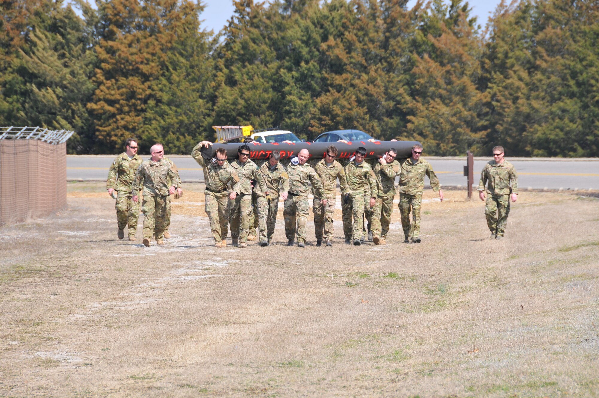 Instructors from the Combat Control School at Pope Field, N.C. participated in carrying a log dedicated to fallen comrade Staff Sgt. Andrew Harvell around the flightline, Mar. 15, 2013.  The log, estimated to weigh 1,250lbs, is carved with the words “Big Andy” on one side and “Victory or Valhalla” on the other.  The 6 mile journey started at the Combat Control School but was shared by members of the 21st Special Tactics Squadron and the 24th Special Tactics Squadron.  (U.S. Air Force photo by Adam Luther, 440 AW/PA)
