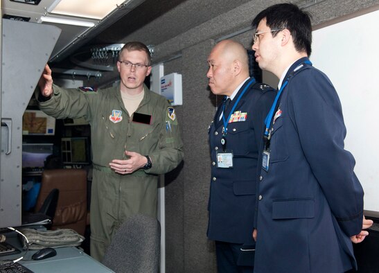 Major Michael (last name withheld due to operations security constraints), 9th Attack Squadron flight commander, explains the operating systems in a ground control station to Col. Junichi Kono, 2nd Section Weapons System Program Division chief, and Maj. Hiroyuki Kobayashi, 2nd Section Weapons System Program Division staff member, at Holloman Air Force Base, N.M., March 19. The Remotely Piloted Aircraft program was briefed to the members of the Japan Air Self Defense Force. Their visit to Holloman AFB was part of an effort to bolster Japanese intelligence, surveillance and reconnaissance capability. (U.S. Air Force photo by Airman 1st Class Colin Cates/Released) 