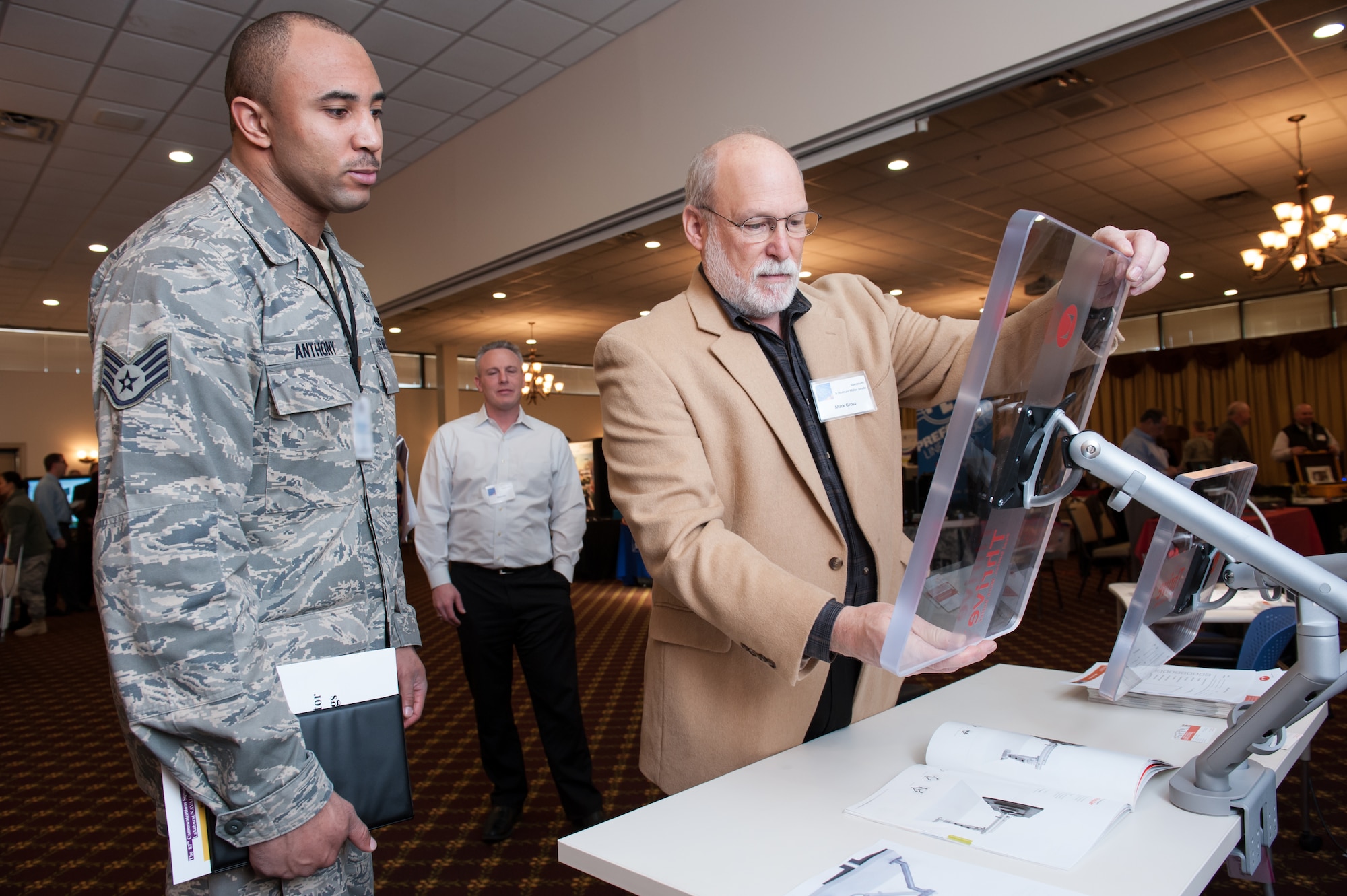 Staff Sgt. Carlton Anthony, 87th Air Base Wing Safety Office ground safety specialists, observes a demo of the Thrive Ergonomic Monitor by Mark Gross, Herman Miller dealer account executive, at the 5th Annual Joint Base McGuire-Dix-Lakehurst Information Technology Expo Mar. 13, 2013, on JB MDL, N.J. The event, held at Tommy B's Community Activities Center, offered the attendee's the opportunity to learn how to maximize their time and productivity in the workplace. Anthony hails from Arlington, Va.(U.S. Air Force photo by Russ Meseroll/Released)