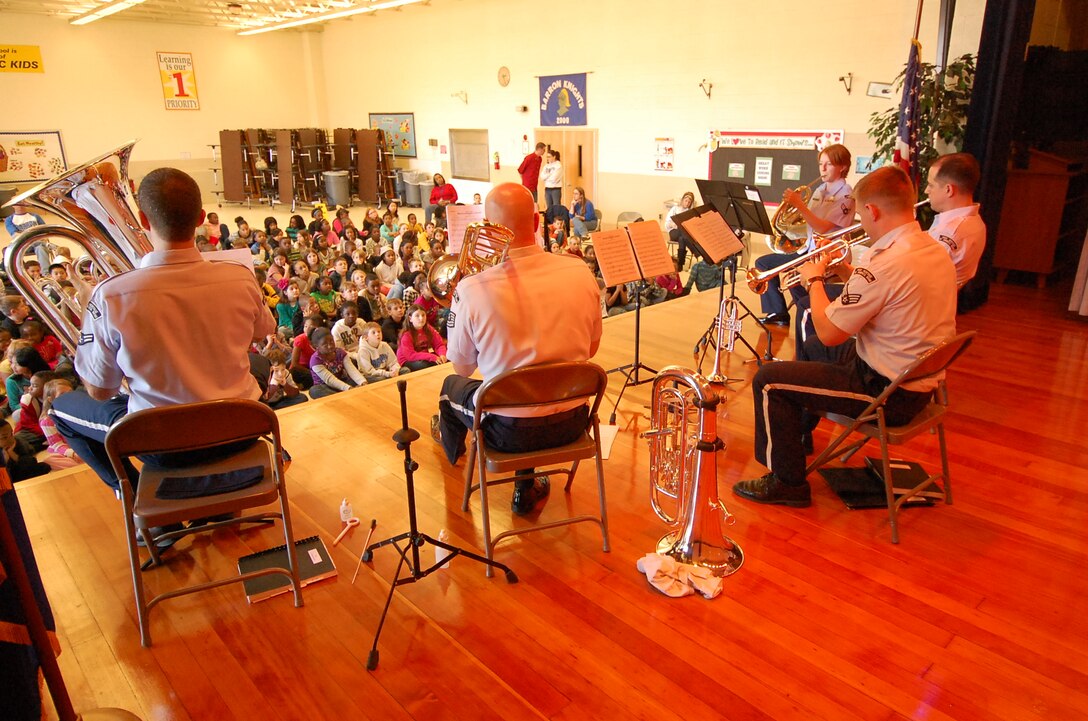 In an effort to reach out to children living in military communities, Heritage Brass performs concerts followed by question and answer sessions in schools near military installations.