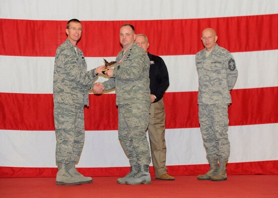Lt. Col. James T. Rich, 325th Maintenance Group deputy maintenance group commander, receives the award for the Capt. Lance P. Sijan Award for Superior Leadership from Col. Curtis Hafer, 325th Maintenance Group commander, and Chief Master Sgt. Terry Gabbert, 325th MXG superintendent, and retired ninth Chief Master Sergeant of the Air Force, Chief Master Sgt. James Binnicker, during the 2012 Maintenance and Staff Professionals of the Year banquet in Hangar 1 March 15. The MPOY banquet recognizes the achievements of the maintenance group and honors maintenance professionals each year. (U.S. Air Force photo by Chris Cokeing)