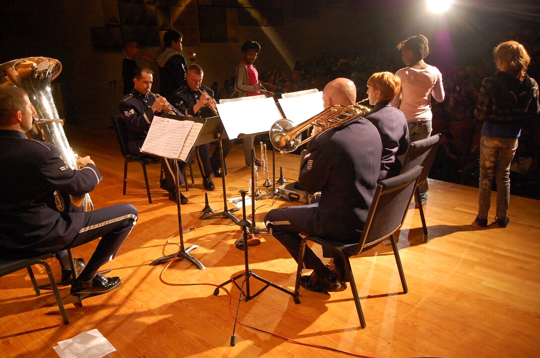 Always encourageing audience participation, Heritage Brass puts audience members on the stage with percussion instruments.