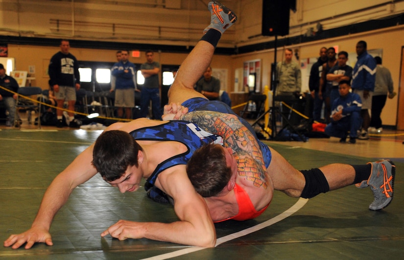 Air Force Nathan Hartley floats Marine Ryan Lyons in response to a gut wrenching in the 84 kg. freestyle match March 17, 2013, at the Armed Forces Wrestling Championship, in Griffith Field House at Joint Base McGuire-Dix-Lakehurst, N.J. Hartley, a Niceville, Fla., native, is stationed at Ramstein Air Base, Germany. Lyons is assigned to Headquarters Support Battalion at Camp Lejeune, N.C. He is a Bayville, N.J., native. (U.S. Air Force photo by Senior Master Sgt. Denise Johnson/Released)